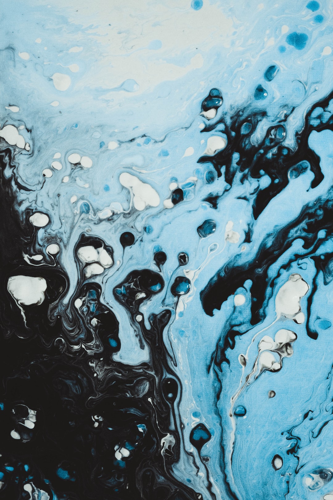 a blue and black abstract painting with bubbles