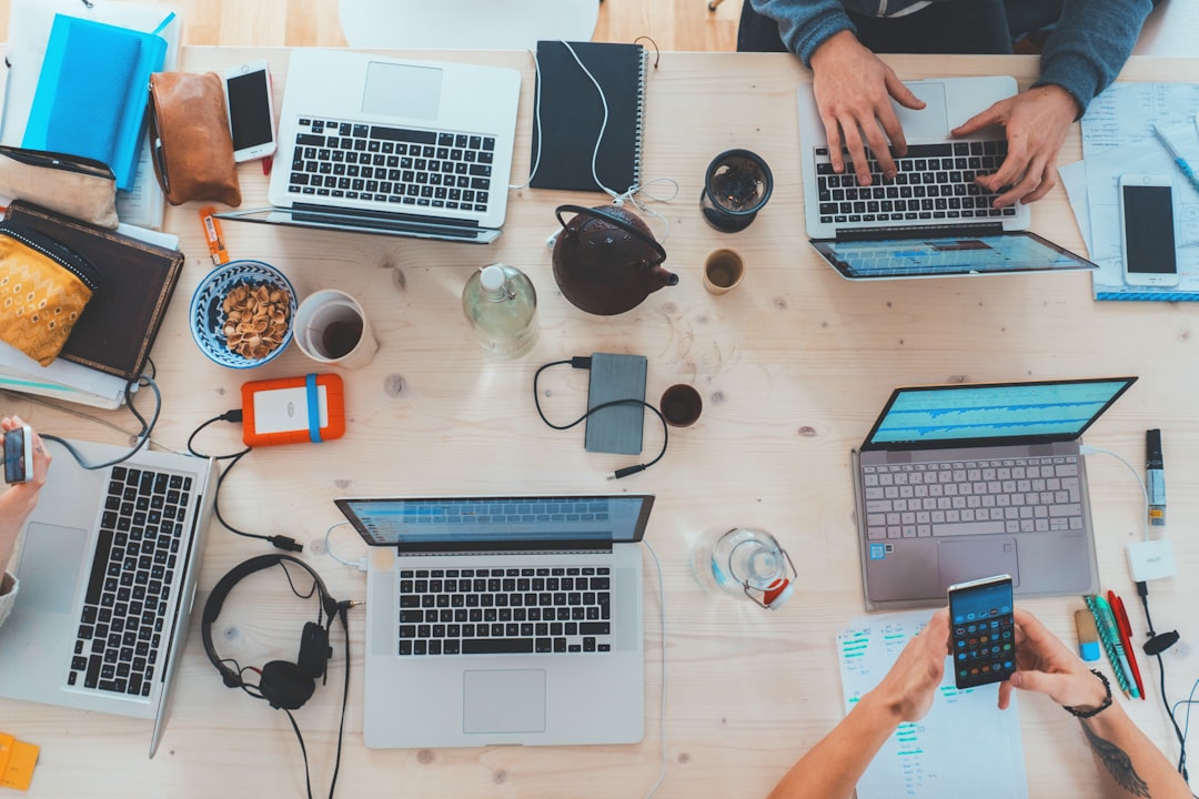 FAQ: Your Burning Questions About Propellerhead Reason Free Refills Answered ❓ by Uniphonic people sitting down near table with assorted laptop computers