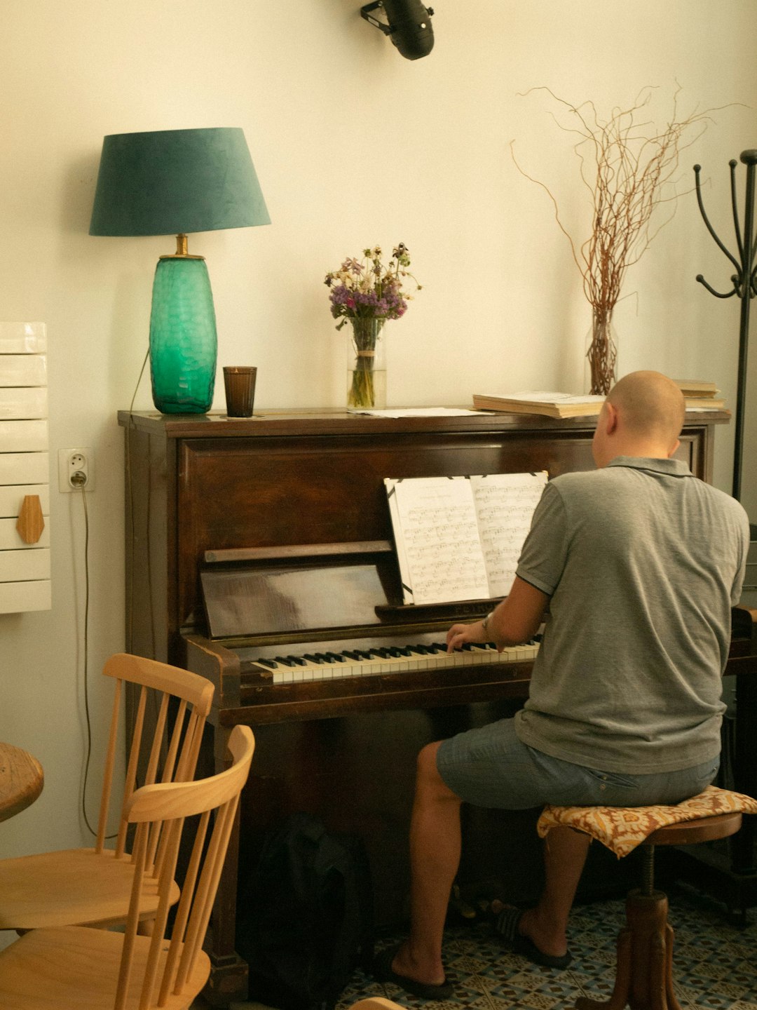 ✅ Conclusion: Your Harmonium Journey Starts Here! by Uniphonic A man sitting at a piano in a living room