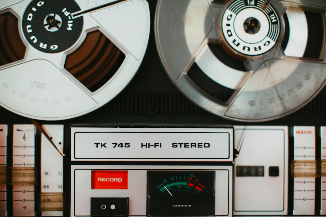 German sound engineering ā magnetic tape recorder music system āĀ TK 745 HI-FI STEREO āĀ Year: 1975 by Uniphonic a close up of two reels on a machine