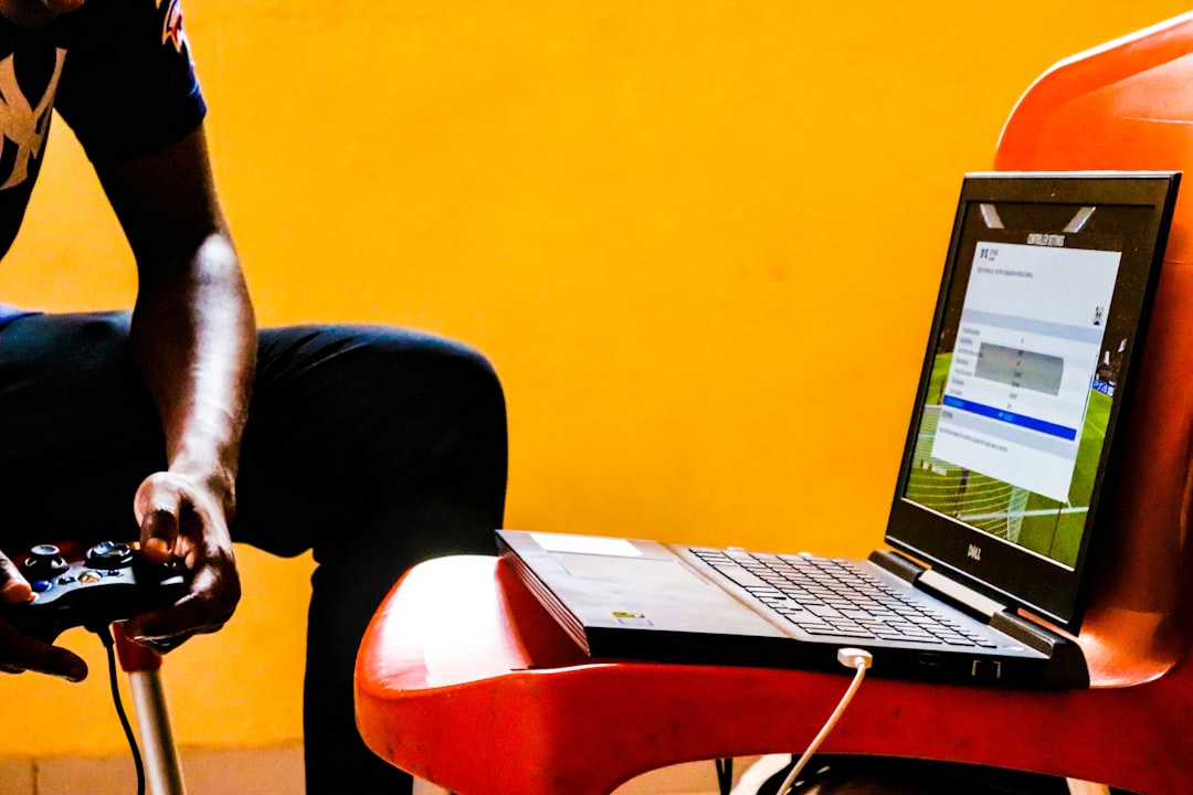 Dell G5 gaming laptop by Uniphonic a man sitting in a chair with a laptop on his lap