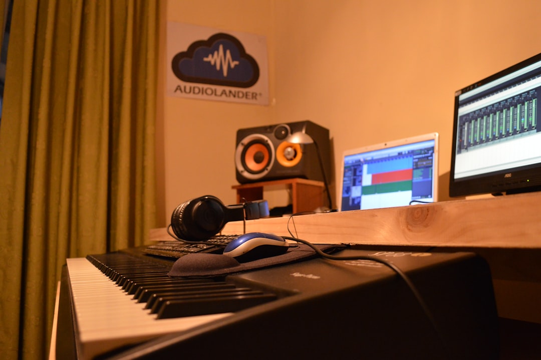 a desk with a laptop and a keyboard