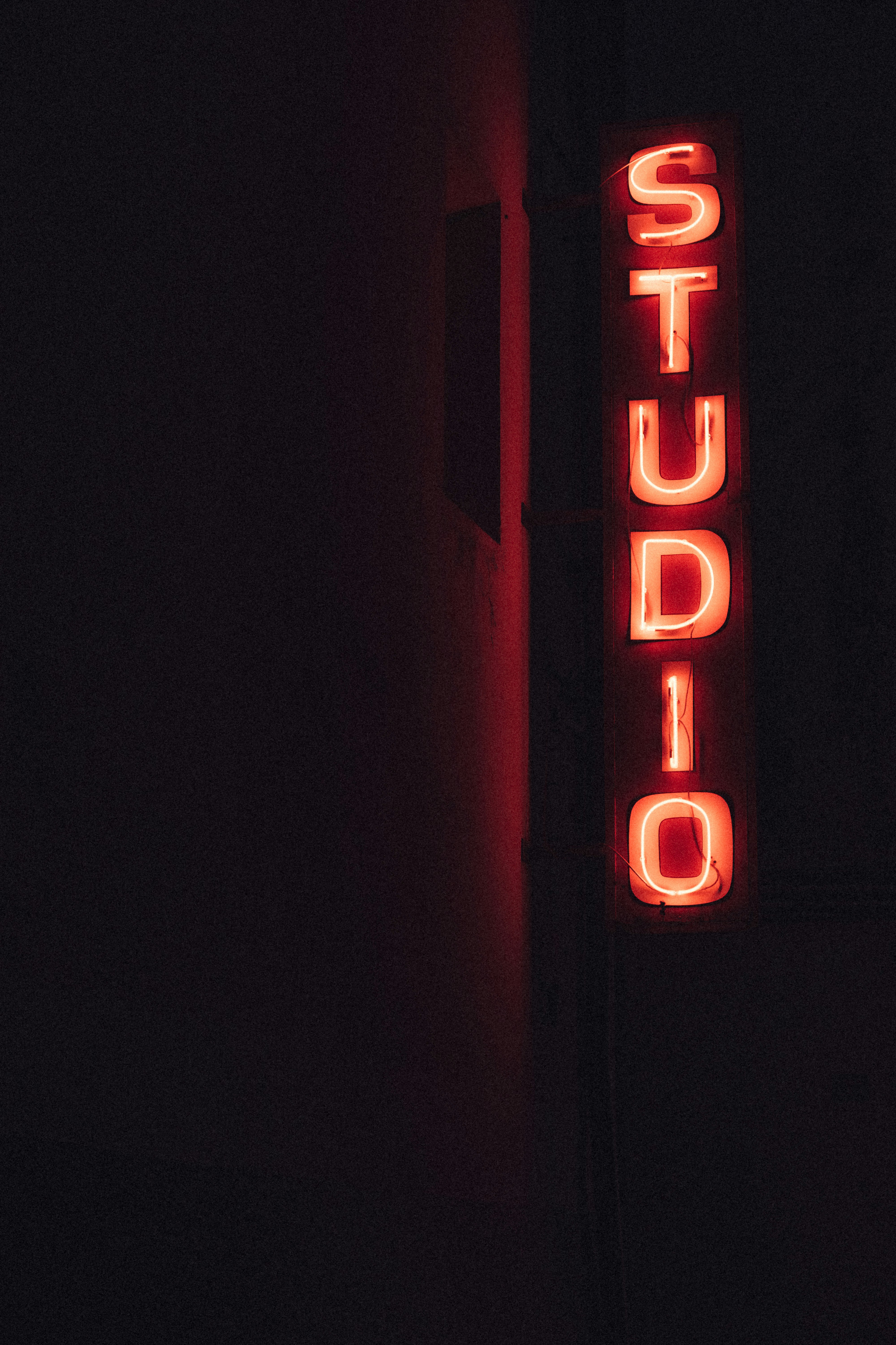 The studio forgot to switch off their sign. Or they're still baking vinyl into the small hours of the night. by Uniphonic lighted red Studio signage